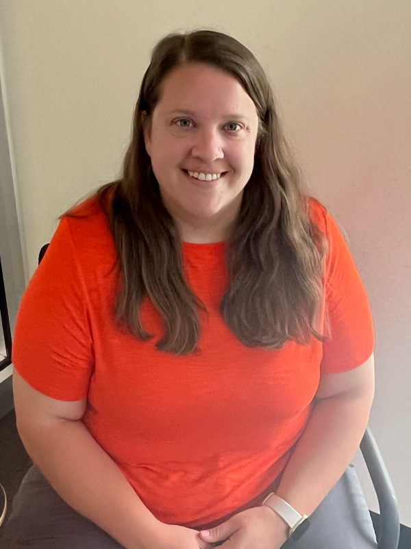 Woman with brown hair and orange t-shirt 